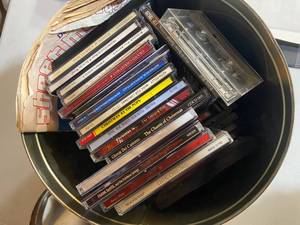 lot 66 image: Assorted Christmas CDs, Cassette Tapes, and Movies in Collectible Tin