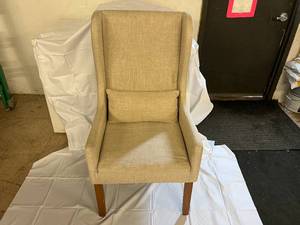 lot 1 image: Beige Upholstered Chair with Lumbar Pillow