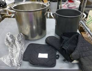 lot 100 image: 2 large stock pots, 15 Qt and the shorter one is a 8 Qt Calphalon