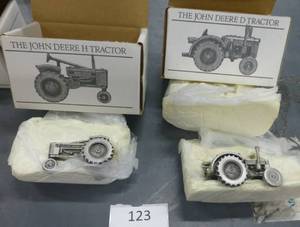 lot 123 image: John Deere Pewter collector series tractors H and D