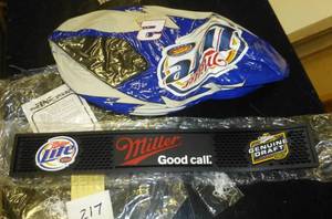 lot 217 image: Miller inflatable racing helmet and New rubber bar rail mat for drinks