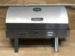 lot 64 image: Cabelas Stainless Steel Tabletop Propane Grill (Retail $89.98)