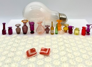 lot 325 image: Vintage Artisan Dollhouse Miniature - Assortment of Purple and Orange Glass and Plastic Vases, Wine bottles, RugCarpet and Crochet Pot Holders