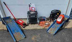lot 25 image: Car Care Bundle - 4 Ton Floor Jack, Convertible Creeper, 2 ramps, 2 floor jacks, trouble light, transfer pump, 10 Amp battery charger and oil collection bin