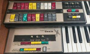 lot 102 image: Super Genie Organ with Bench, Lamp and Song Sheets  (44 W x 34.5 H x 23 D)