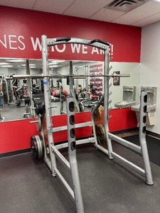 lot 3 image: Matrix Squat Rack. Barbell included but weigh plates are not included. Measures 61 W X 70 D X 88 H.