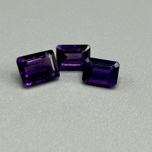 lot 26 image: 3.59 Carat Amethyst Faceted Rectangular Emerald Cut - Set of 3 Loose Stones