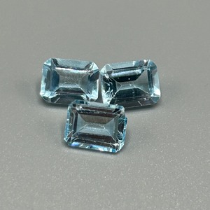 lot 61 image: 9.08 Carat Blue Topaz Faceted Rectangular Emerald Cut - Set of 3 Loose Stones