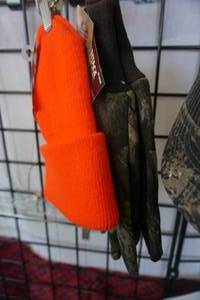 lot 134 image: Hot Shot Brand Blaze Orange Stocking Cap, White Water Outdoors Camo Glove and Real Tree Baseball Cap