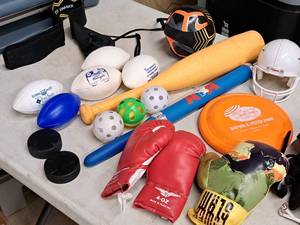 lot 128 image: Lot of  Assorted Sporting Goods - Whiffle Balls and Bats, Plastic Footballs, Boxing Gloves, Small Football Helmet, Frisbie