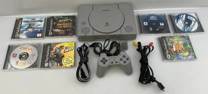 lot 176 image: Vintage PlayStation With Games