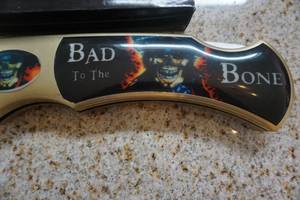 lot 31 image: United Cutlery Model XL1255 Bad to The Bone Monster Folding Knife