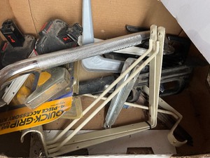 box of shelf brackets and new faucet