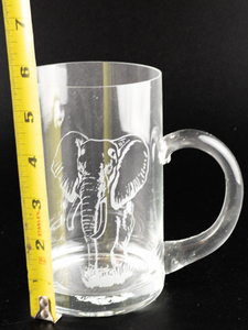 lot 292 image: Glass 5 12in Beer Mug with Etched Elephant Design (Logo on base)