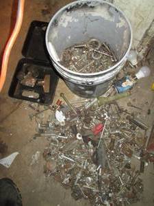 lot 79 image: 5-gallon bucket plus a Large heap of automotive nuts, bolts, and other hardware