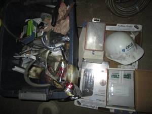 lot 90 image: Tote plus fruit box full of assorted tools and supplies including a hard hat, cable modem and more