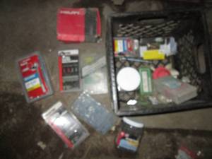 lot 93 image: Milk crate of new anchoring hardware and other supplies