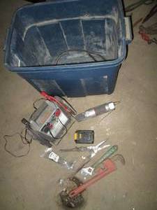 lot 132 image: Pipe Wrench, battery booster with other tools and supplies