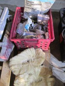lot 254 image: Milk crate of ass door knobs, plumbing supplies and window air conditioner cover