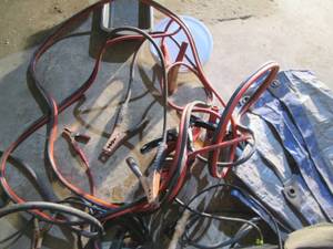 lot 255 image: Tote of assorted contractor tool belts and bags, jumper cables and more