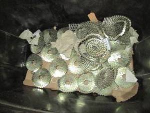 lot 259 image: Tote with layers of coil roofing nails