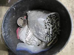 lot 42 image: 5-gallon bucket of lag bolts and threaded cement inserts