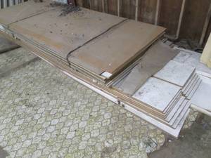 lot 50 image: Massive lot of particle board and a couple sheets of plywood