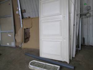 lot 147 image: Huge lot containing 4ft8ft white board, locking advertisement board, decorative wall panels, solid core interior wood doors, window panes, lighted desks and more bring proper truck andor trailer as well as physical help for removal