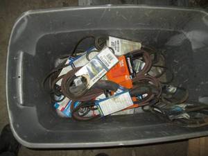 lot 275 image: Storage tote of GoodYear and Power Care drive belts with misc other automotive supplies