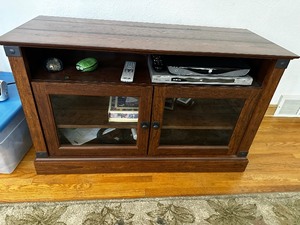 lot 134 image: Wood And Glass Entertainment TV Stand With Sony DVD Player And TiVo Measuring 43 Inches Wide By 17 12 Inches Deep By 26 Inches Tall