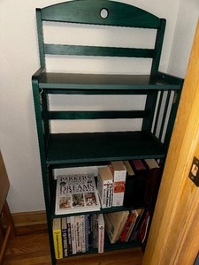lot 37 image: Green Folding Bookcase Measuring 22 Inches Wide 11 Inches Deep And 52 Inches Tall Books Included