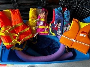 lot 407 image: Bin Of Swim Noodles And Lifejackets
