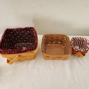 lot 8 image: Three Vintage Longaberger Baskets 8 By 8 By 4 12 Deep 6 By 6 12 By 6 12 By 3 12 Inches Deep 3 12 By 3 12 By 2 12 Inches Deep Both Have sleeves And Protectors The 3rd Just As A Protector.