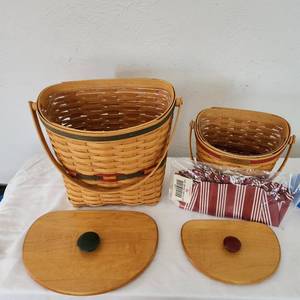 lot 11 image: 2 Vintage Longaberger Baskets 1st 11 And Three Quarter By 7 12 By 11 The 2nd 8 By 6 By 9 Both Have Covers Sleeves And Protector The First Is Called Winter Wishes The Second Glad Tidings Both Are Part Of The Christmas Collection.