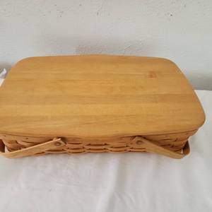 lot 9 image: Vintage Longaberger Basket, 16 One Half By 10 By 4 Inches Deep With Cover And Two Handles With Protector.
