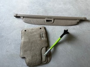 lot 49 image: Jeep Cargo Cover In Tan 56 Inches, Jeep Branded Floor Mats, Step Plates, & Ice Scraper