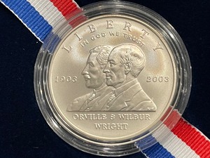 lot 93 image: 2003-P First Flight Silver Dollar - 53,761 Minted