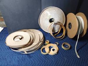 lot 278 image: 3 rolls of cardboard tack strip, about 200 yds of double strand upholstery piping, roll of adhesive foam, double sided tape plus other tape and a strip of veneer