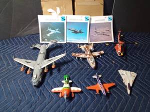 lot 325 image: 5 Die cast airplanes and 1 helicopter and 6 packs of military cards of military planes and their history