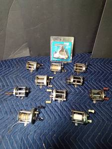 lot 330 image: 11 Vintage fishing reels including 1 new in pkg. (see details for brands and model #s)