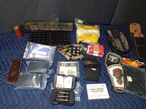 lot 336 image: Toy pistol holder, 3 new damage screw removing kits, ammo belt case, buttstock shell carrier, strap on cleats, knife sheath and more