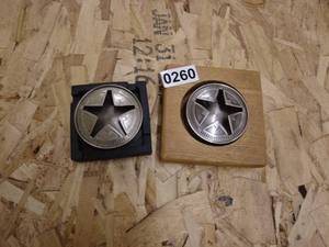 lot 260 image: Two Star Emblem Metal Coasters with Wood and Black Holders
