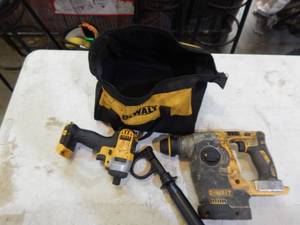 lot 29 image: DeWalt 20 volt brushless hammer drill works and quarter inch driver for parts with bag