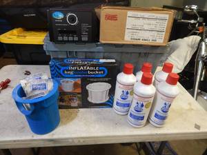lot 90 image: Tote full of pool chemicals and inflatable cooler
