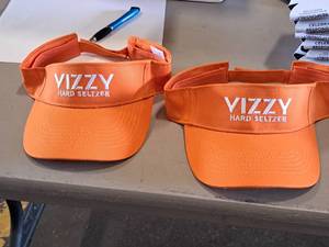 lot 138 image: Lot of (2) Vizzy Hard Seltzer logo Visors