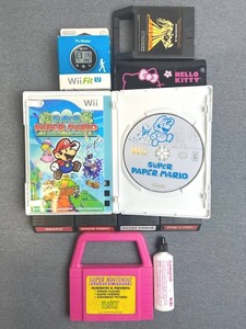 lot 63 image: Neat Video Game Lot including Vintage Intellivision, Wii Super Paper Mario, Nintendo Wii Fit U Fit Meter (New Sealed), Hello Kitty Nintendo 3DS Case, Odyseey 2 BowlingBasketball, and Super Nintendo Cleaning System