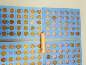 2 Whitman Folders with Lincoln Cents--Includes 87 Wheat Cents, 1 Unc.  Roll of 1961 and 1 Unc. Roll of 1963 Cents