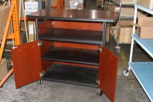 lot 39 image: Rolling Wood  Wooden Mobile Desk Cabinet with Heavy Duty Casters Locking Doors & Power Distribution
