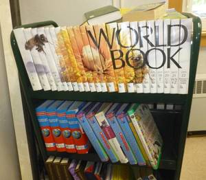 lot 208 image: Rolling double sided book shelf and contents - Dictionarys and Encyclopedia