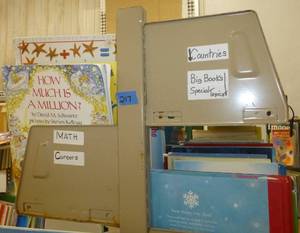 lot 217 image: Shelving unit and books -Math, careers, countries, winter, holidays, Pooh, jokes